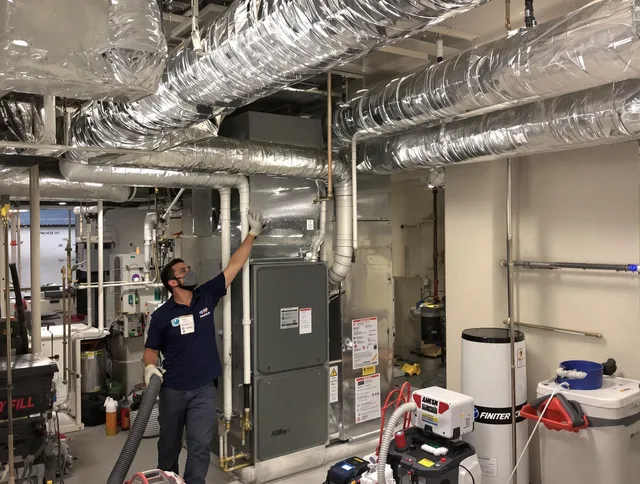 Warren Air Duct Cleaning specialist performing thorough furnace duct cleaning in a Warren residence