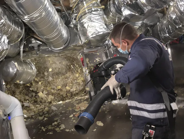 Warren Air Duct Cleaning specialist operating negative pressure cleaning equipment for thorough duct maintenance in Warren