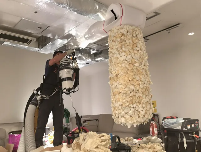 Warren Air Duct Cleaning technician performing precision vacuum insulation removal in a residential property in Warren